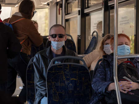 Moscow. Russia. October 4, 2020. A man in a city bus wearing a protective medical mask.のeditorial素材
