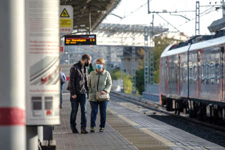 Moscow. Russia. October 4, 2020. A group of passengers wearing medical masks on a subway station platform await boarding a train.のeditorial素材