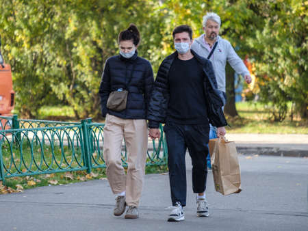 Moscow. Russia. October 4, 2020. People in protective medical masks walk through the city. Sunny...