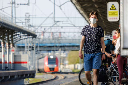 Moscow. Russia. October 4, 2020. A young man in a protective medical mask on the platform of a railway stationのeditorial素材