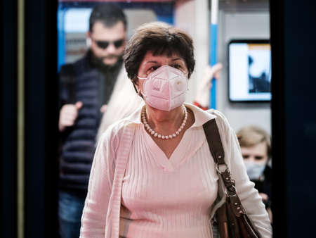 Moscow. Russia. September 25, 2020. A young woman with a protective mask on her face stands in a...