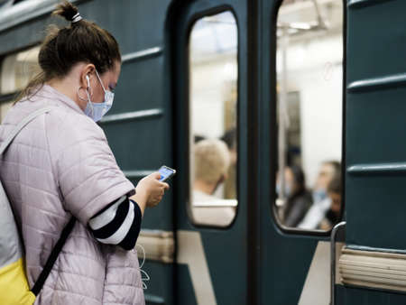 Moscow. Russia. September 25, 2020 A young girl in a protective mask stands on a subway station...