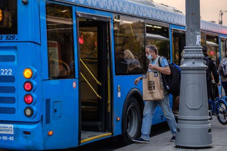 Moscow. Russia. On September 25, 2020, a man wearing a medical mask walks through the open doors of...