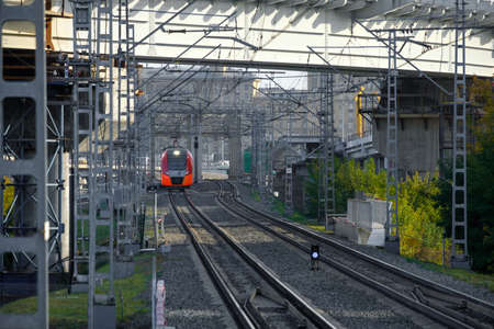 A modern high-speed red train on a section of the Moscow Central Circle Line.
