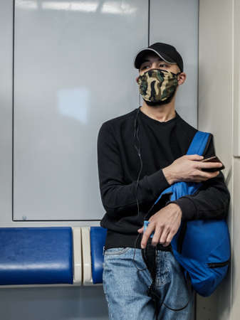 Moscow. Russia. October 5, 2020 A man in a subway car is looking at his smartphone with enthusiasm.