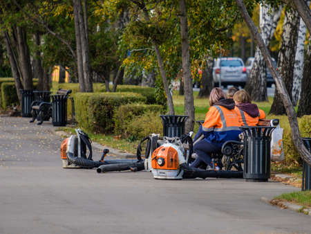Moscow. Russia. On October 11, 2020, a group of utility workers relax on a park bench.のeditorial素材