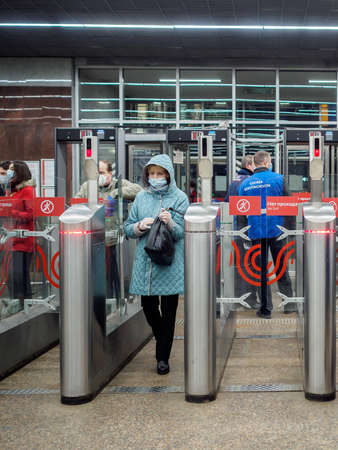 Moscow. Russia. October 29, 2020. Passengers pass through automatic turnstiles at the Moscow metro...