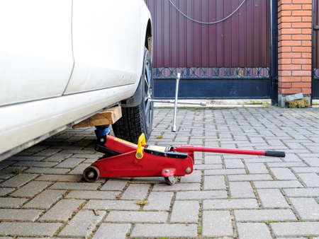 The wrench is sticking out of the wheel rim of the car.の写真素材