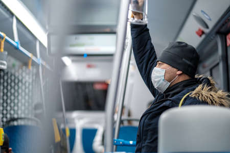 Moscow. Russia. November 11, 2020. A man in a city bus wearing a protective medical mask.
