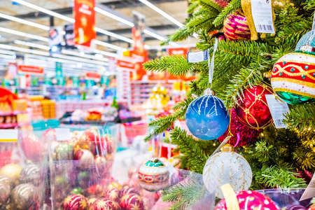 Moscow. Russia. November 22, 2020: Colorful Christmas balls on the branches of a Christmas tree in a department store. New Years Eve sale of tree decorations and Christmas toys.のeditorial素材