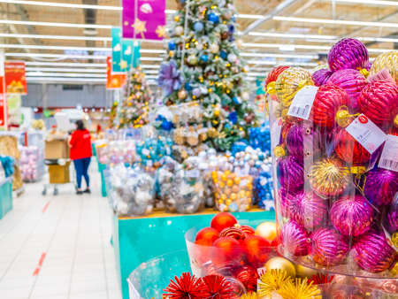 Moscow. Russia. November 22, 2020: Colorful Christmas balls are sold at the department store. New Years Eve sale of tree decorations and Christmas toys.のeditorial素材