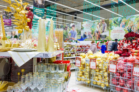 Moscow. Russia. November 22, 2020: The department store sells a variety of New Years decor. Candles, crockery, cutlery. New Years Eve sale of tree decorations and Christmas toys.のeditorial素材