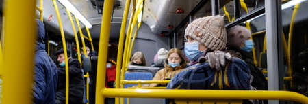 Moscow. Russia. November 24, 2011. A young girl in a medical mask is standing on the bus. Measures...