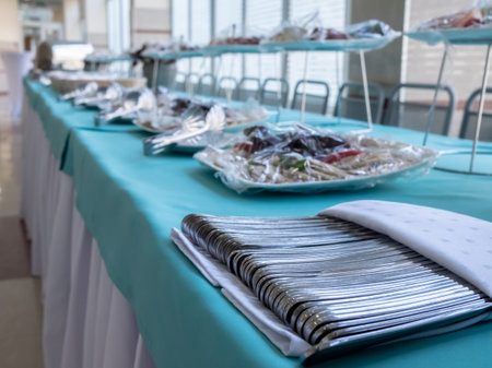 Selective focus on metal cutlery on the table. Banquet setting. Catering.