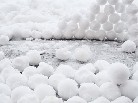There are many round snowballs in the snow. Winter fun. Abstract new year christmas background. Copy space.の写真素材