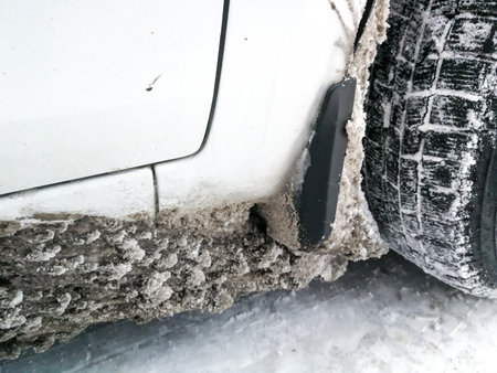 The wheel arch of the car is clogged with ice and snow. Consequences of heavy snowfall and frost. Difficulties in operating transport.の写真素材
