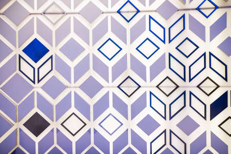 Photo of the surface of a luminous wall with three-dimensional shapes of triangles, lines and squares. Abstract design background.の写真素材