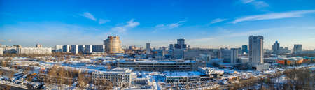 Moscow. Russia. February 16, 2021. Panoramic aerial view of the Konkovo urban area on a sunny winter day. Cloudless blue skies over residential and industrial buildings.のeditorial素材