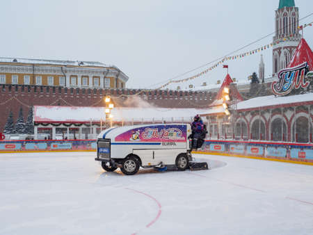 Moscow. Russia. February 12, 2021. The Red Square. A car cleans snow from and polishes the ice on the skating rink of the main department store on a winter day during a snowfall.のeditorial素材