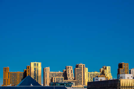 Panoramic view of unknown modern city buildings. Clear blue sky background.の写真素材