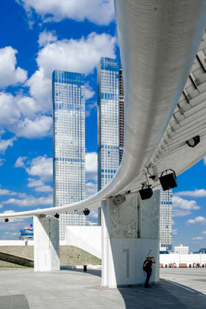 Moscow. Russia. May 26, 2021. Unknown modern skyscrapers against the blue sky with clouds. Curved...