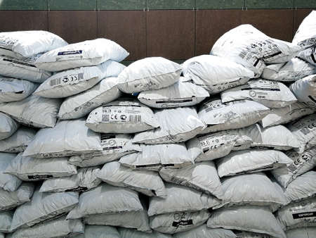 Moscow. Russia. June 18, 2021. A large pile of white plastic bags filled with expanded clay on a sunny day outside.のeditorial素材