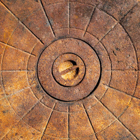 An old rusty cast-iron surface with a relief pattern in the form of lines and circles. Flat layout. Abstract background.の写真素材