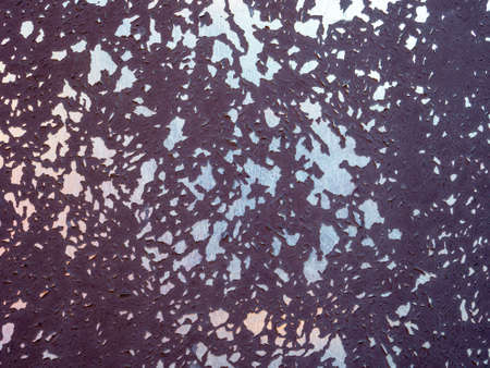 Surface of galvanized metal sheet with peeling burgundy paintの写真素材