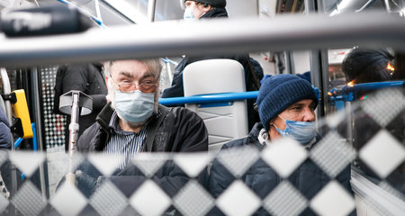 Moscow. Russia. October 22, 2021. Male passengers in protective masks in a city bus. Wearing medical masks on public transport to protect against COVID19 infectionのeditorial素材