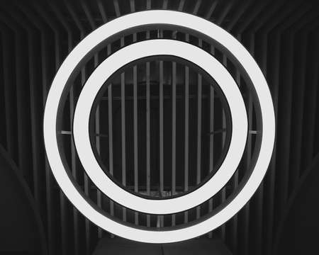 Luminous led ring lamp on the ceiling. Bottom view. Black and white image.の写真素材