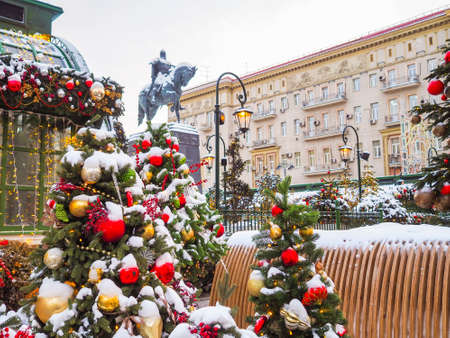 Moscow. Russia. December 23, 2021. Colorful decorations and balls on New Years trees on the street in Moscow. Christmas trees covered with snow near the monument to Yuri Dolgoruky. Selective focus.のeditorial素材
