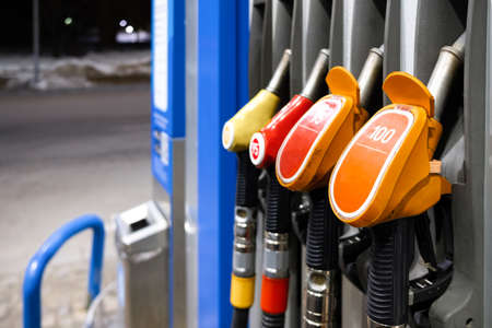 Close-up of a fuel pump pistol grip at a gas station. Selective focus. The concept of rising fuel prices. fuel crisis.の写真素材