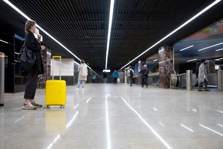 Moscow. Russia. May 24, 2021. Yellow suitcase on the floor in the lobby of the subway station....