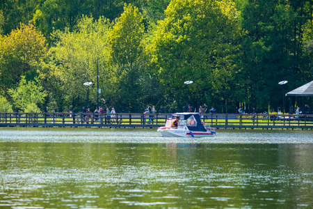 Moscow. Russia. May 21, 2022. Rescue boat on the Meshchersky pond in Moscow on a summer day. The work of the rescue service on the reservoir.のeditorial素材