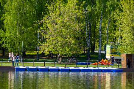 Moscow. Russia. May 21, 2022. Empty blue boats at the boat station in the city pond on a sunny day.のeditorial素材