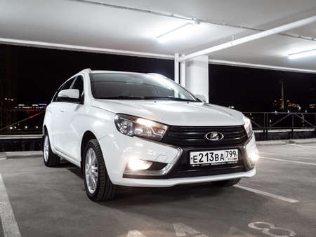 Moscow. Russia. September 15, 2021. White Lada Vesta SW station wagon in an empty multi-storey car park at night. Lada Vesta SW is a modern Russian car.のeditorial素材
