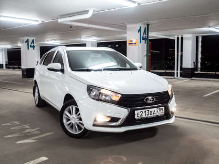 Moscow. Russia. September 15, 2021. Modern beautiful Russian car Lada Vesta SW. A white station wagon in an empty multi-storey car park at night.のeditorial素材