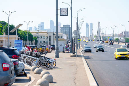 Moscow. Russia. June 9, 2022. Lots of bicycles and electric scooters for rent in a special parking lot on the street in Moscow on a summer day. Alternative environmentally friendly transport.のeditorial素材