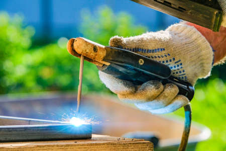 A bright flash of an electric arc when welding metal with electric arc welding. Selective focus.