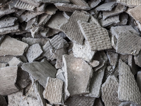 Lots of pieces of old broken slate. Chaotically scattered pieces of broken asbestos.の写真素材