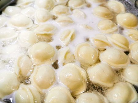 Delicious dumplings with meat are boiled in hot boiling waterの写真素材