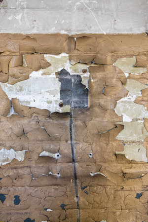 Fragment of an old brick wall with peeling paint. Background texture of dirty grunge wall.の写真素材