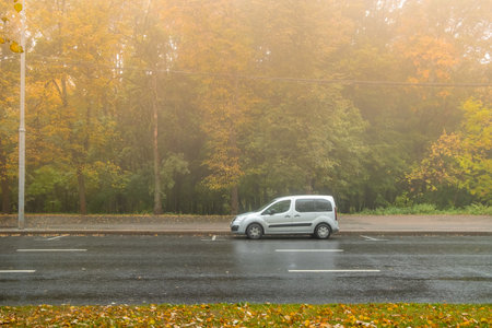 Moscow. Russia. October 04, 2022. Silver minivan Opel Combo Life, Peugeot Partner or Citroen Berlingo in the park on a foggy autumn morning. Soft focus.のeditorial素材