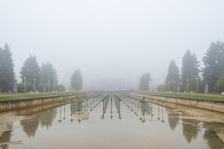 The pool of a non-working city fountain in a dense fog on an autumn morning outdoors.の写真素材