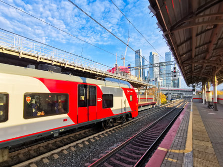 MOSCOW. RUSSIA. October 15, 2022. Panoramic view of the station of the Moscow Central Ring against the backdrop of the Moscow City skyscrapers. High-speed city train at the station in Moscow.のeditorial素材