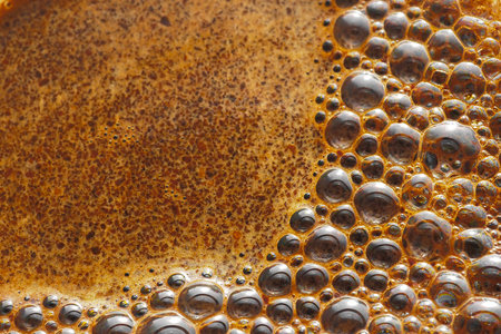 Bubbles of coffee foam close-up. Selective focus. The texture of the coffee foam of freshly brewed aromatic coffee. Food background.の写真素材
