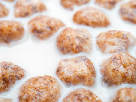 Selective focus on corn balls in milk close up. Healthy breakfast of corn flakes and milk.