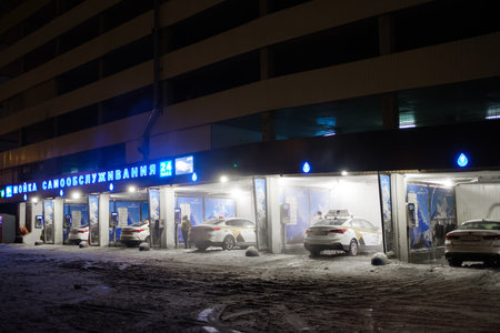 Moscow. Russia. November 18, 2022. Taxi cars in self-service car wash boxes on a winter night.のeditorial素材