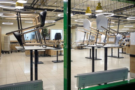 Moscow. Russia. November 26, 2022. Chairs on a table in an empty mall restaurant after work is completed.のeditorial素材