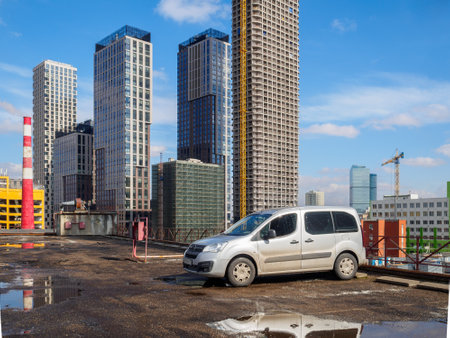Moscow. Russia. April 1, 2023. Car Opel Combo Life in the city against the backdrop of high-rise buildings under construction.のeditorial素材